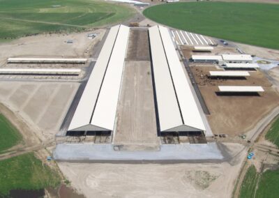 Aerial view of a spacious warehouse building with multiple loading docks and rows of parked trucks