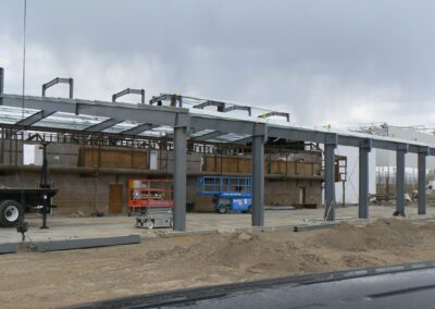 a building under construction with a truck and a trailer