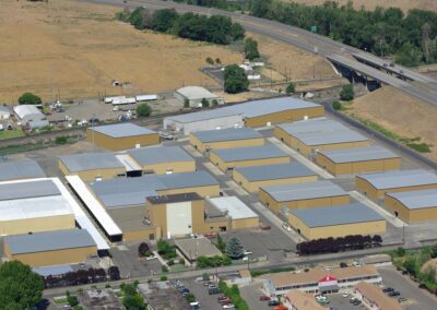 Aerial view of a spacious warehouse building with multiple loading docks and rows of parked trucks